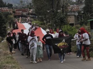 HUT RI a group of people walking on a road